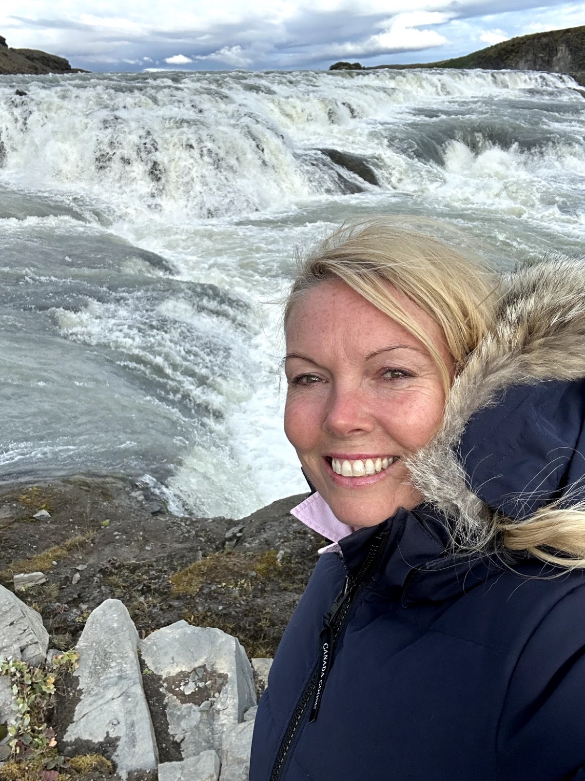 Annissa Krueger beside a waterfall in Iceland