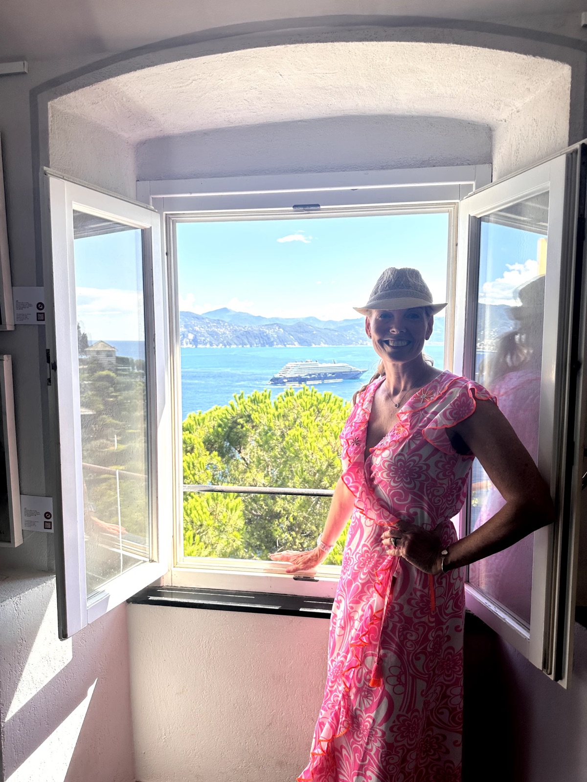 Annissa Krueger at an open window overlooking the Italian coast