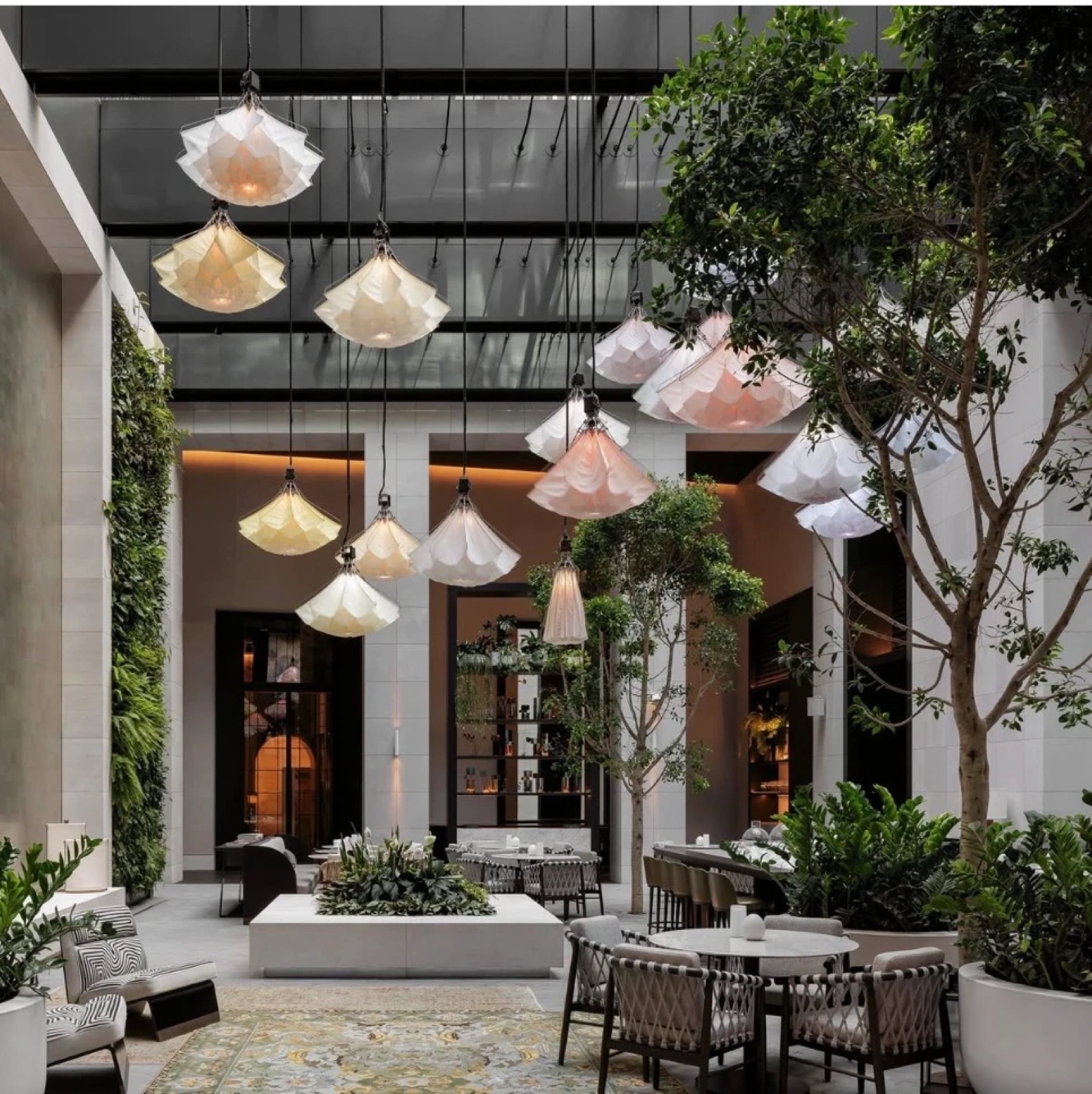 Courtyard of a luxury hotel, lanterns hanging between the trees