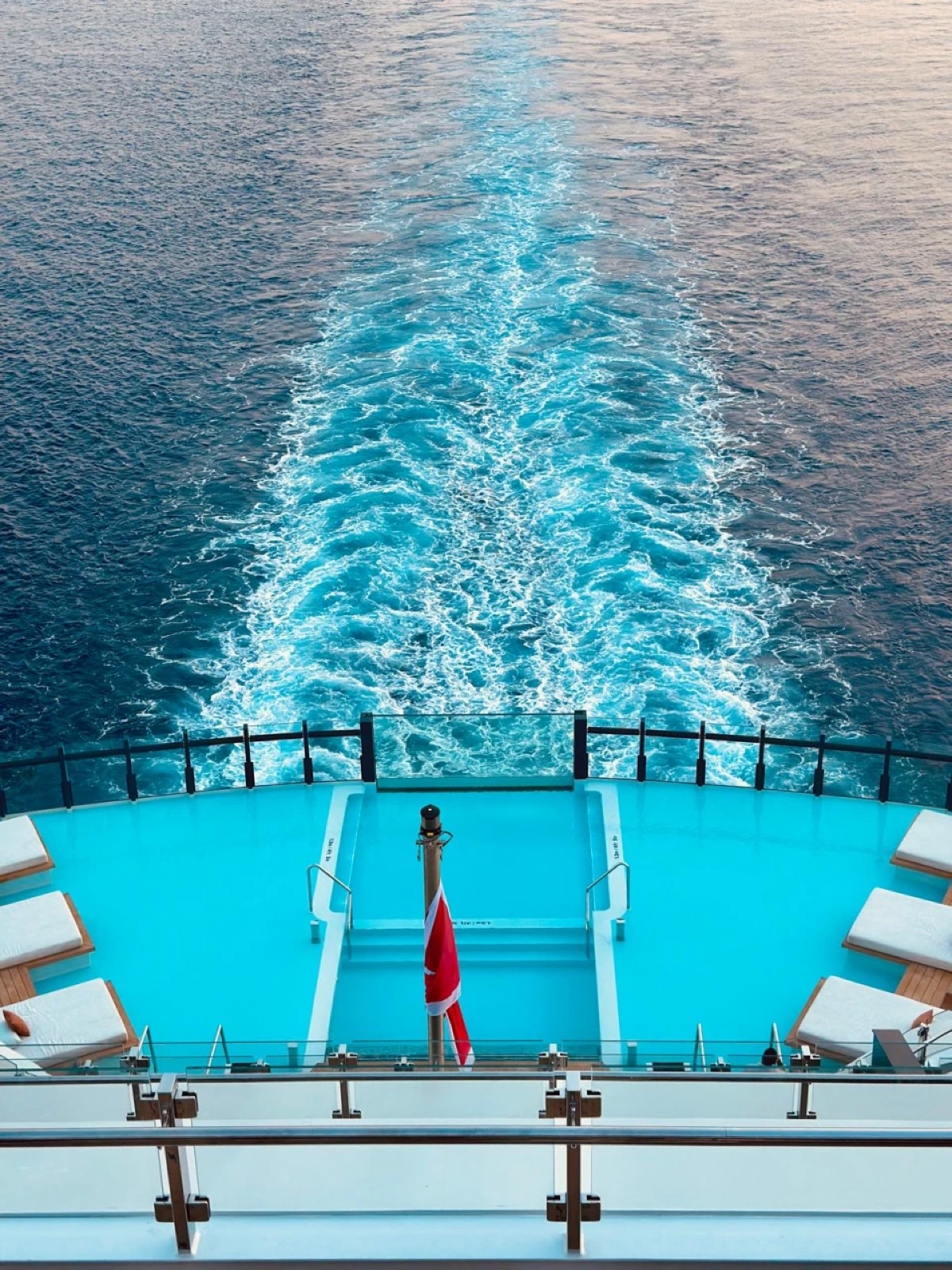 The wake of a Ritz-Carlton yacht seen from its stern pool deck